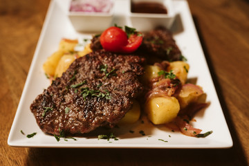 Steak with vegetables, potato and sauce  in the restaurant