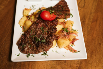 Steak with vegetables, potato and sauce  in the restaurant
