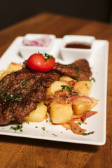 Steak with vegetables, potato and sauce  in the restaurant