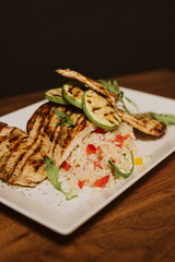 Grilled chicken with rice and vegetables by the glass of juice
