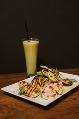 Grilled chicken with rice and vegetables by the glass of juice
