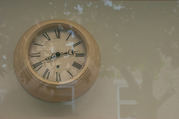 Vintage clock hanging at the wall.