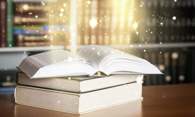 Stacked books on desk at library