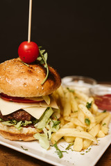 Hamburger with French fries and sauce in a restaurant