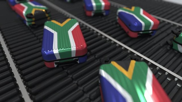 Many travel suitcases featuring flag of South Africa on roller conveyer. Tourism related conceptual animation