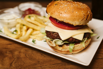 Hamburger with French fries and sauce in a restaurant