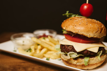 Hamburger with French fries and sauce in a restaurant