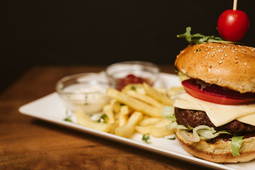 Hamburger with French fries and sauce in a restaurant