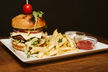 Hamburger with French fries and sauce in a restaurant