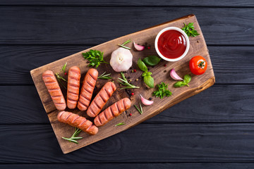Fried sausages with herbs , spices and ketchup