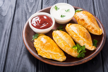 Latin American baked beef empanadas with sauce