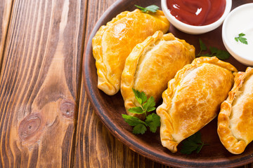 Latin American baked beef empanadas with sauce