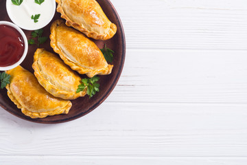 Latin American baked beef empanadas with sauce