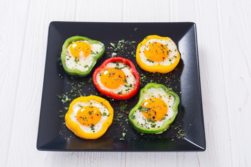 Yellow , red and green pepper with fried eggs