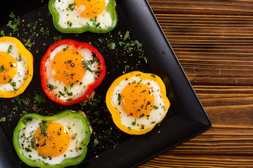 Yellow , red and green pepper with fried eggs