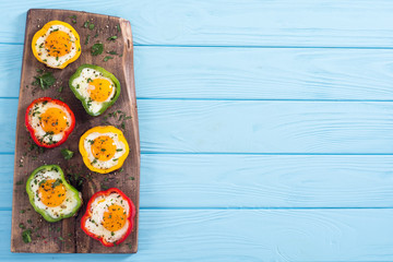 Yellow , red and green pepper with fried eggs