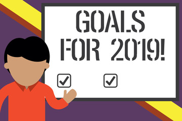 Writing note showing Goals For 2019. Business concept for object of demonstratings ambition or effort aim or desired result Young man standing in front whiteboard pointing to project. photo Art