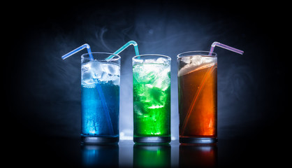 collection of colorful shots with lemon on bar; set of alcohol mini cocktail shooters with lime;