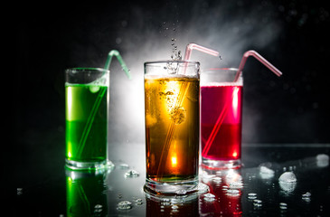 collection of colorful shots with lemon on bar; set of alcohol mini cocktail shooters with lime;