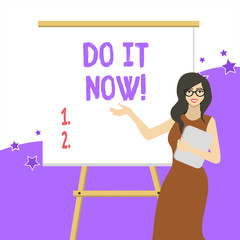Handwriting text writing Do It Now. Conceptual photo not hesitate and start working or doing stuff right away White Female in Glasses Standing by Blank Whiteboard on Stand Presentation