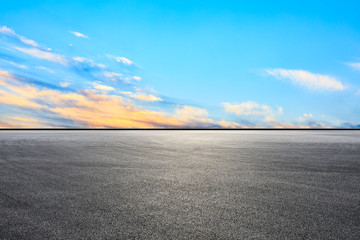 Fototapeta premium Empty asphalt race track and sunset sky