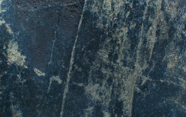 The texture of the stone. Dark background. Relief surface