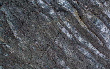The texture of the stone. Dark background. Relief surface