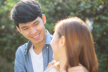 Beautiful portrait couple looking each others eyes and smiling with happy, young asian man and...