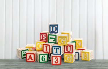 Colorful wooden block with letters on the wooden desk