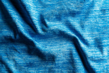 A uniformly lit blue fabric texture with soft shadows.