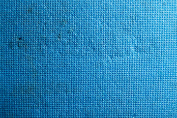 Bright blue texture consisting of small squares with scratches and scuffs
