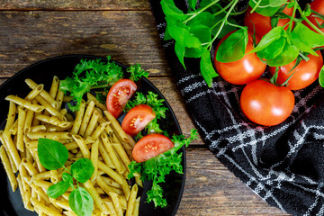 Cooked pasta with tomatoes, basil and fresh vegetables.