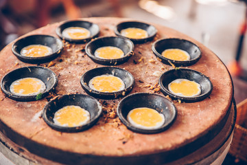 Vietnamese mini fried eggs, cooking on the street - Traditional Vietnamese food