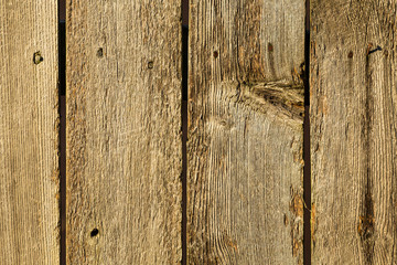 Old Wooden Plank Fence with Well Defined Grain and Knot Holes Useful as BG or Screen Saver