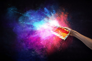 Man`s hand holding a small magic paper box, mixed media