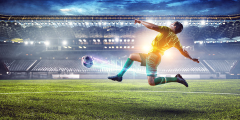 Obraz na płótnie Canvas Soccer player on stadium in action. Mixed media