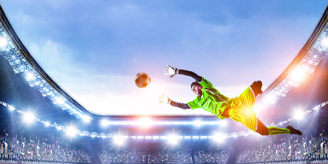Soccer player on stadium in action. Mixed media
