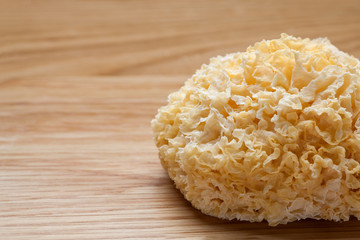 Dried white fungus (Tremella fuciformis) on wooden table