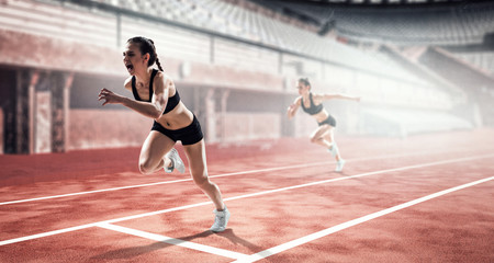 Woman sprinter in action on stadium