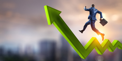 Black businessman running on green zigzag increasing arrow