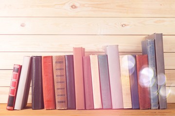 Ancient books in a row on wooden