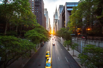 Sunset over 42nd Street with the colorful lights of traffic through Midtown Manhattan, New York...