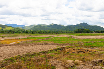 Fields, mountains and blue sky and clouds