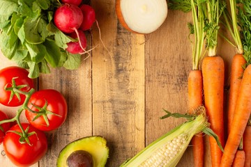 Frame with fresh vegetables. On wooden background. Veggie set.flat lay. Harvesting. Gastronomy