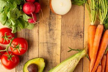 Frame with fresh vegetables. On wooden background. Veggie set.flat lay. Harvesting. Gastronomy