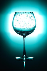 Empty wine glass.  isolated on bright green and black background.