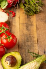 Fresh vegetables on wooden background. Top view. Vertical photo. Vegetarian sets. Harvest. Gastronomy