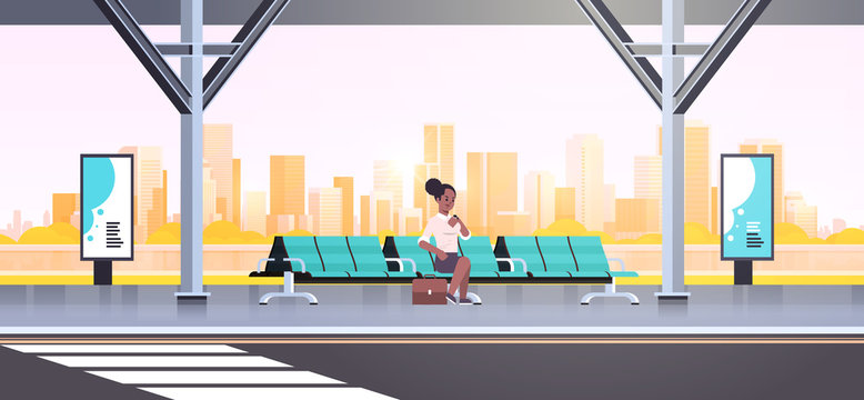businesswoman sitting modern bus stop african american woman checking time waiting public transport on airport station cityscape background flat horizontal full length