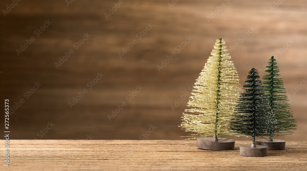 Poster christmas tree on wood table with wooden wall for merry chirstmas and new year holiday greeting card