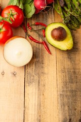 Fresh vegetables on wooden background. Top view. Vertical photo. Vegetarian sets. Harvest. Gastronomy